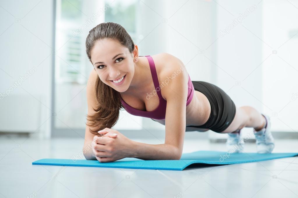 depositphotos 78294354 stock photo smiling woman exercising at the